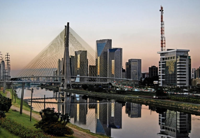 Sao Paulo landmark at dusk. Octavio Frias de Oliveira Stayed Bridge and modern buildings and districts of the skyline.