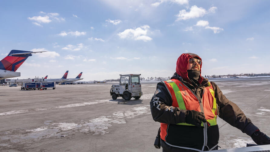 A Delta Aircraft Load Agent works in winter conditions at Minneapolis-St. Paul International Airport (MSP).