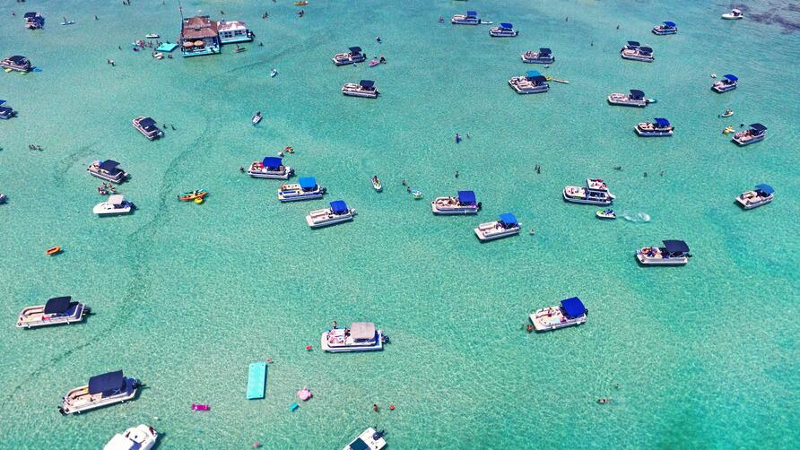 Aerial view of boats on crystal blue waters in Destin, Florida