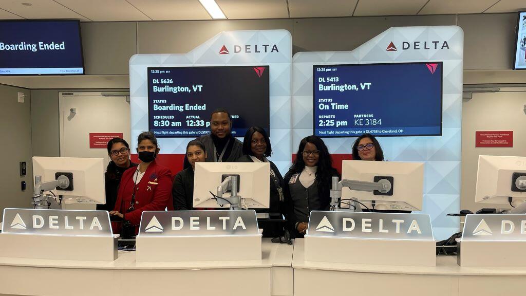 Delta employees stand at a gate in Delta's newly consolidated Terminal 4 at New York City - JFK.