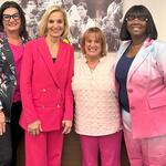 EVP and Chief People Officer Allison Ausband posing with three Delta employee breast cancer survivors.