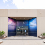 Exterior entrance of a building featuring Delta and Paramount+ Star Trek 60 branding, with colorful space-themed graphics surrounding glass doors.