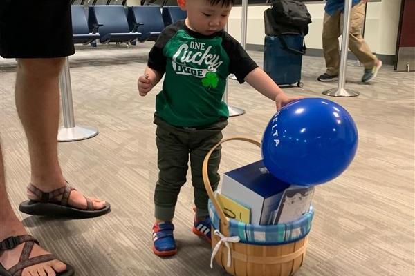 Beau checks out the balloons given to him by the Delta staff.