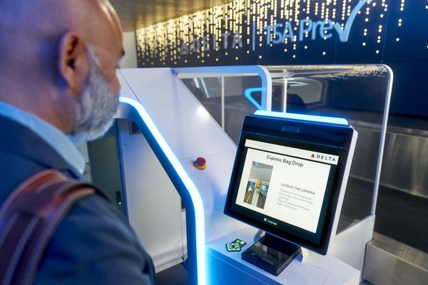 A man uses facial recognition technology to check in.