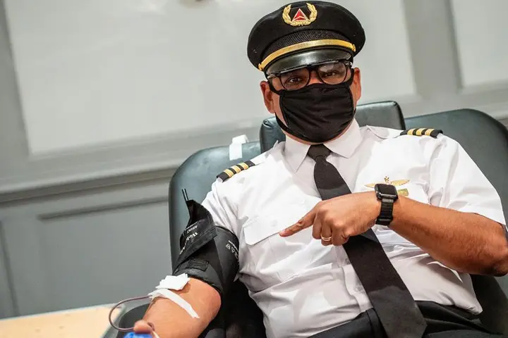 Captain Joe Pinkelton with mask giving blood