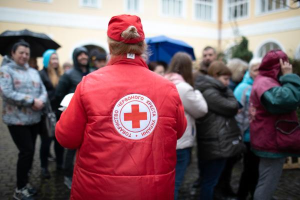 A Red Cross worker helps people in Ukraine.