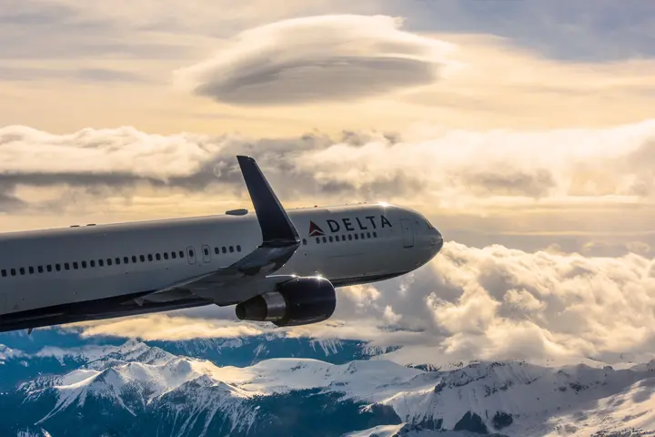 A 767-300 in-flight near the snow capped mountains of Mount Rainier, Seattle.