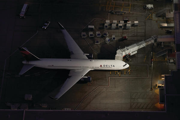 A 767-300 sits near a terminal at LAX airport.