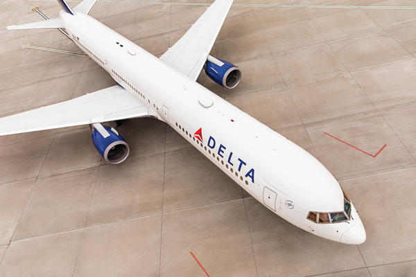 Delta's Boeing 767-400 model, over 200 feet long, navigates the runway for takeoff.