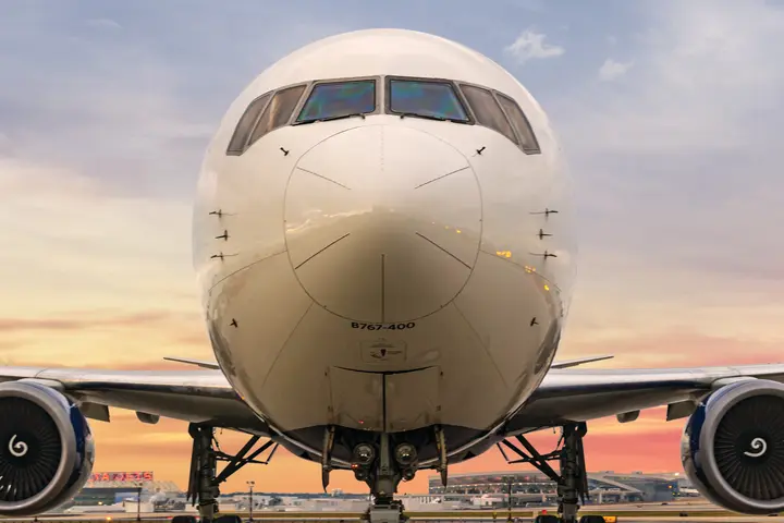 Delta's Boeing 767-400 stands forward facing with a gradient sky background. 