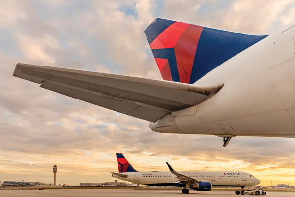 Overlooking an afternoon skyline near the Atlanta headquarters, Delta's Boeing 767-400 dorsal area features a wingspan of 171 feet and a tail height of over 50 inches.