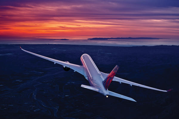 A350-900 in flight against a sunrise