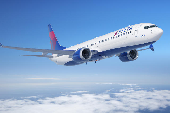 Boeing 737-10 in flight over clouds