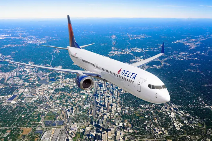 Boeing 737-10 MAX in flight over city