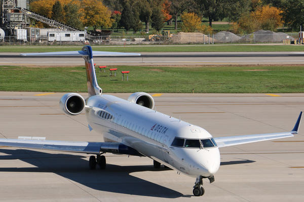 The Delta Bombardier CRJ-900, which seats 70-76 passengers, sits on the runway. 