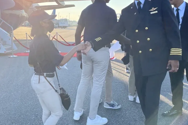 A Delta pilot greets a student participating in the 2022 Dream Flight