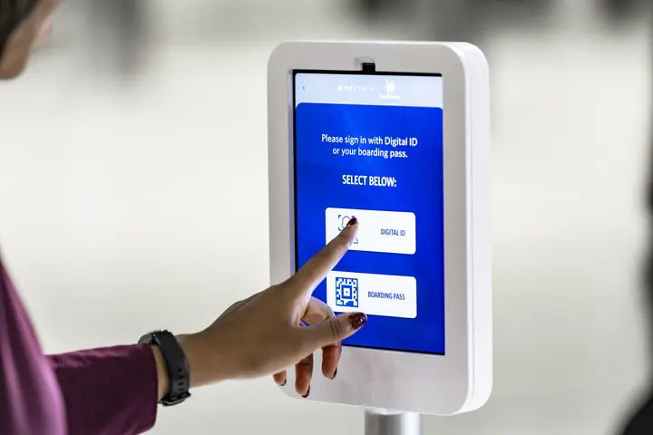 Female customer using Parallel Reality screen to check-in
