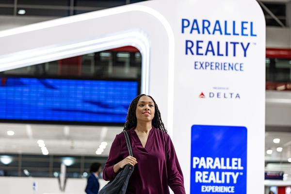 Female customer walking through Parallel Reality Experience archway at airport