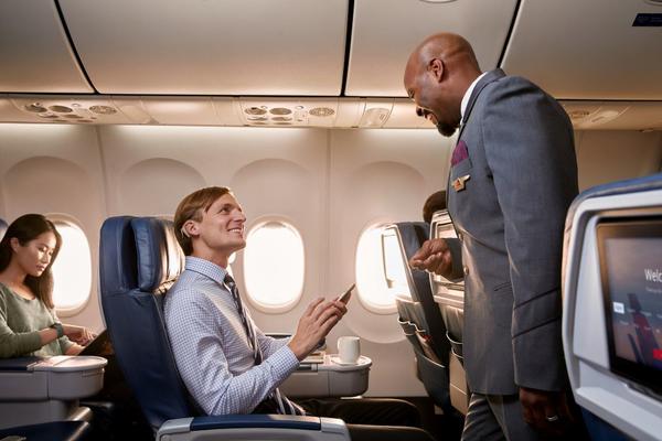 Flight attendant helping customer on board