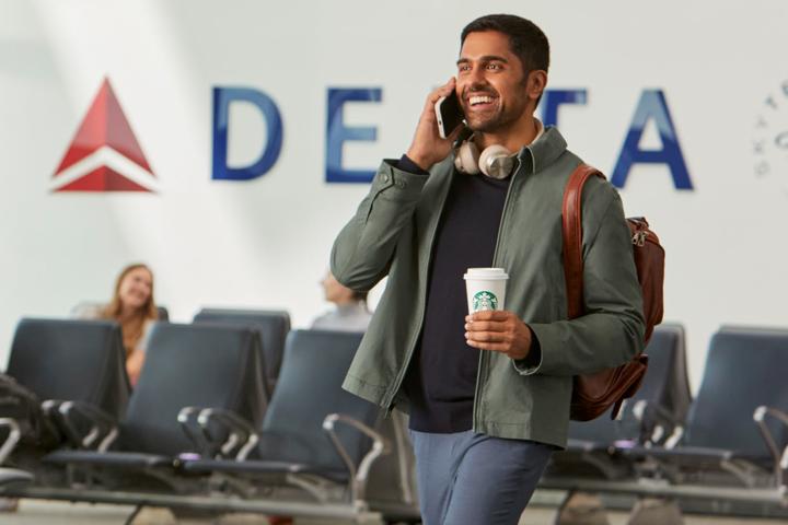 Traveler in airport enjoying Starbucks beverage