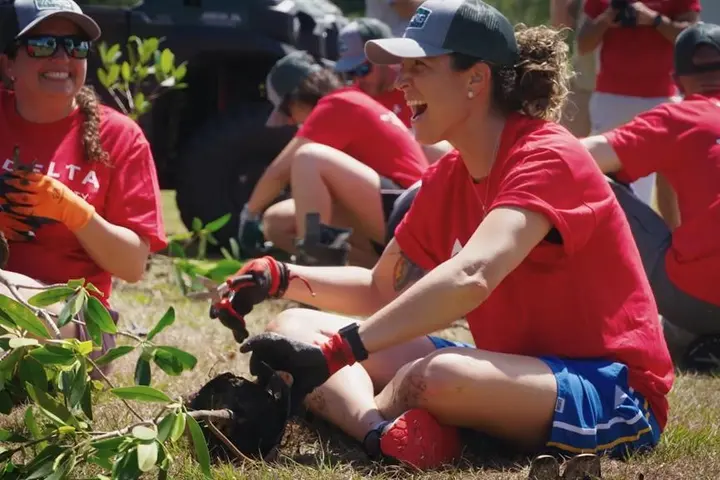 Delta employees participate in a tree planting in 2022.