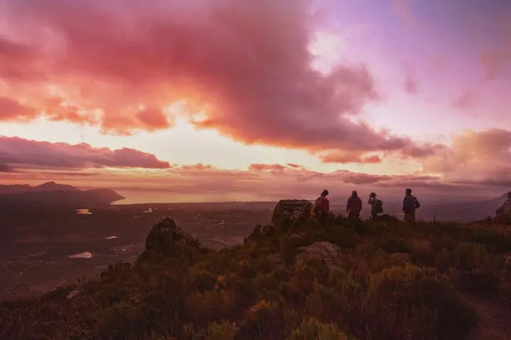 People on a mountaintop with a colorful sunset for Delta's new "Kaleidoscope" brand spot.
