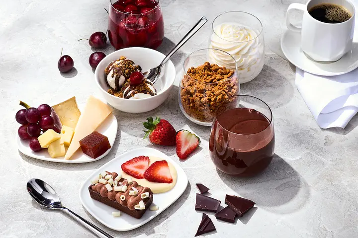 The Delta One dessert carts features a variety of treats like opera cake with chocolate ganache; Cowgirl Creamery wagon wheel, Midnight Moon gouda, and grapes.