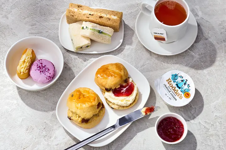An afternoon tea pre-arrival menu selection in Delta One features scones, tea sandwiches, mini pastries and more.