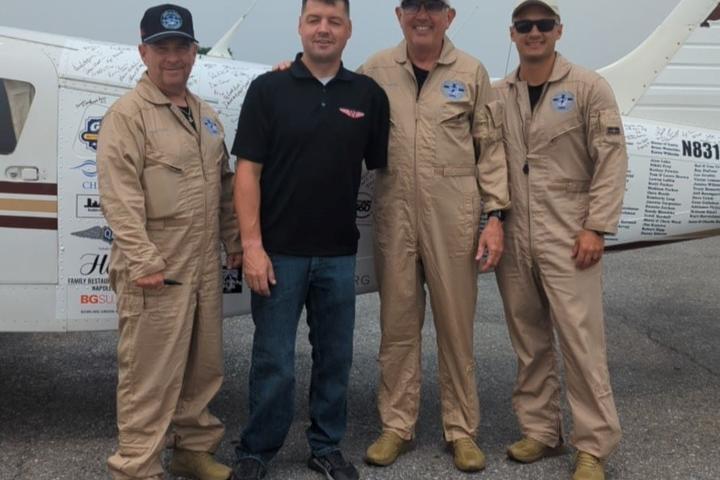 The members of the 48N48 mission pose with Adam Kisielewski, a combat-wounded veteran and member of the Veterans Airlift Command advisory board, during their stop in Maryland.