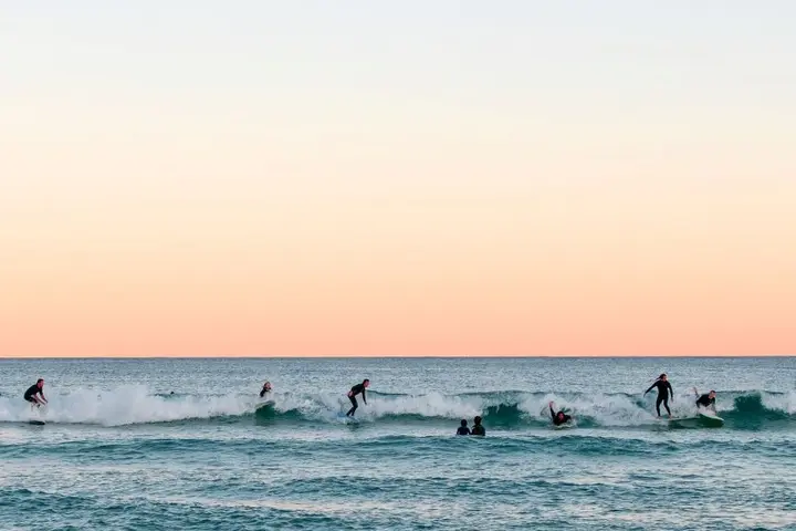 Surfers catch waves at Bondi Beach in Sydney, Australia
