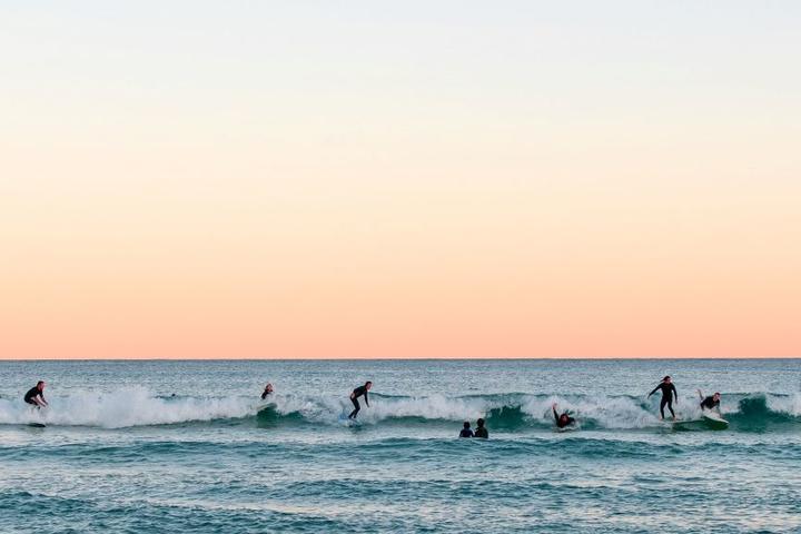 Surfers catch waves at Bondi Beach in Sydney, Australia