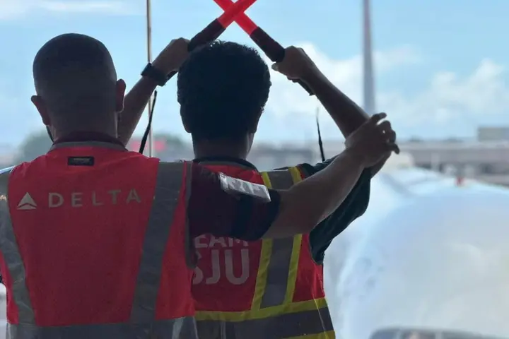 A Delta employee works with a child at San Juan Airport as part of a special initiative to inspire excitement about aviation.
