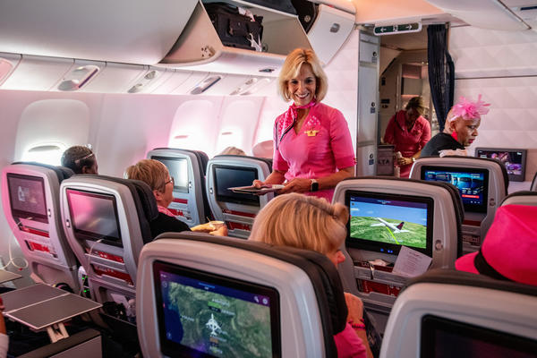 Delta leader Allison Ausband performs flight attendant duties on Delta's Breast Cancer One charter flight.