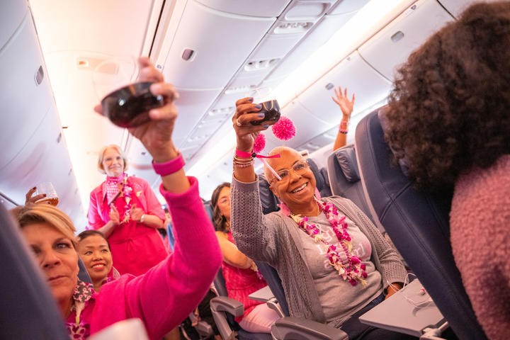 Delta people onboard the Breast Cancer One charter flight raise a toast.