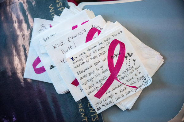 As part of the Breast Cancer One charter flight experience, notes were written on napkins to breast cancer survivors and fighters.