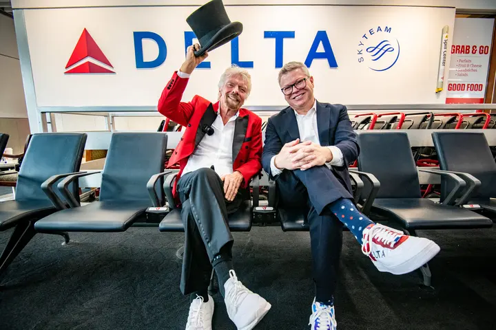 Sir Richard Branson and Delta Chief Marketing & Communications Officer Tim Mapes post for a photo during an event with Virgin Voyages.