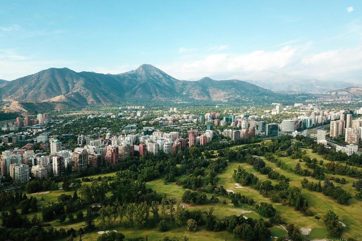 A scenic view of Santiago, Chile with mountains behind a city