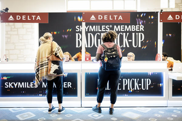 Visitors approach the expedited SkyMiles Member Badge Pick-Up at the Austin Convention Center Rotunda Foyer during SXSW 2024.