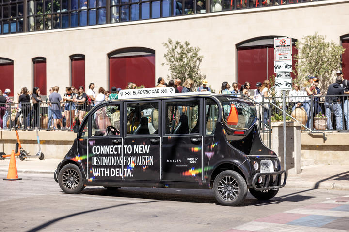 An electric Delta-branded hopper transports members looking for a ride throughout downtown Austin. The hoppers were available throughout the duration of SXSW 2024, with complimentary rides to the Austin Convention Center, the Delta Lounge or any local downtown destination.