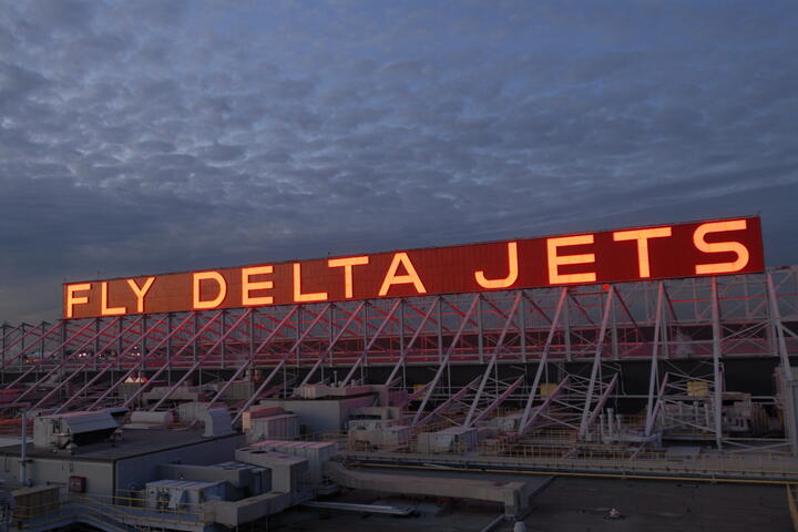 Lit up Fly Delta Jets sign at the Delta World Headquarters in Atlanta