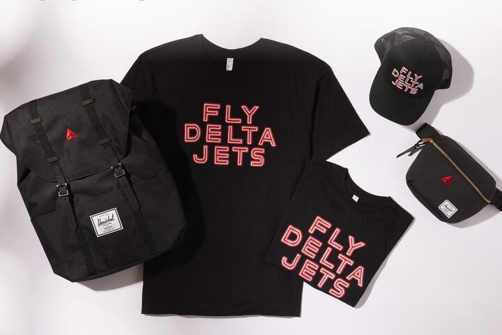 Fly Delta Jets logo on t-shirts and a hat along with the Delta widget on a backpack and fanny pack