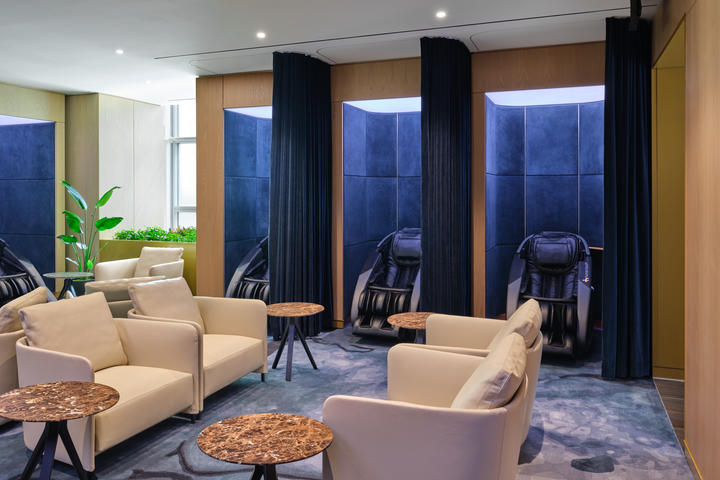 Prepare for the journey ahead in the designated wellness area, equipped with nine reservable relaxation pods with full-body massage chairs and nap chairs, treatments from Grown-Alchemist certified therapists, and more.