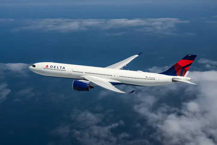 An A330-900 flying among clouds