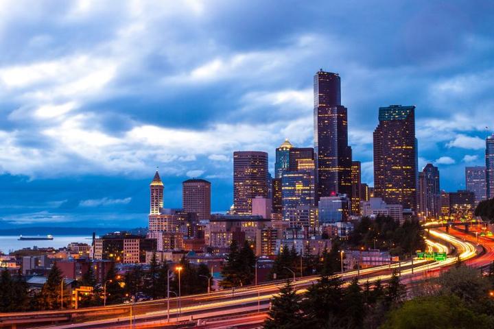 An image of downtown Seattle, lit up at night.