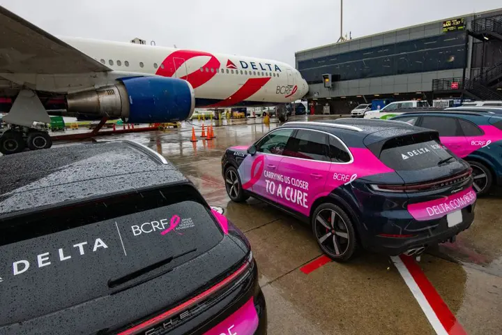 BCRF plane awaits takeoff amidst BCRF branded Porsches on September 26, 2024.