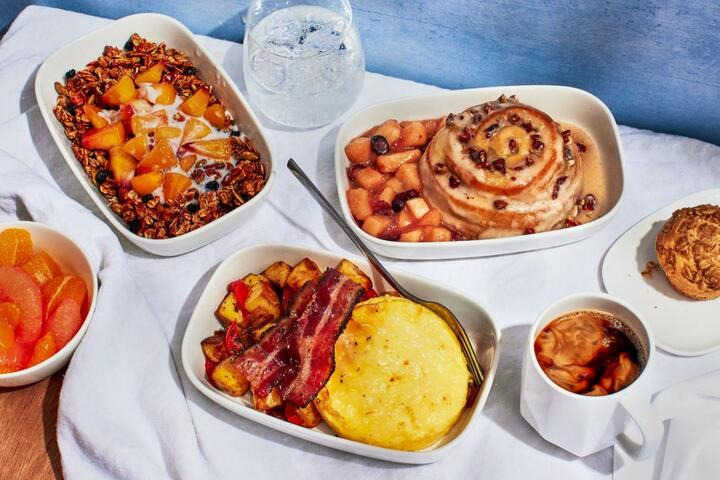 Breakfast, lunch and dinner options curated by Chef Mashama Bailey on domestic First Class flights where meal service is offered out of Atlanta. For breakfast, rise and shine with bacon and eggs with homestyle potatoes and white cheddar cheese; pecan honey bun with apple-cranberry compote; or Grey Market pecan granola with peach compote and almond milk. 