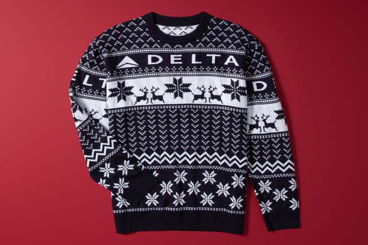 Show off your love for travel this winter with our Navy Delta Holiday Sweater. Cozy and colorful, this sweater is perfect for any festive occasion. 