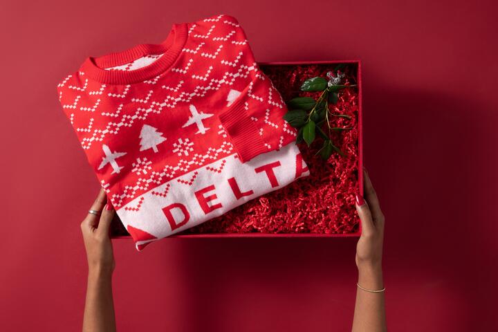 Show off your love for travel this winter with our Red Delta Holiday Sweater. Cozy and colorful, this sweater is perfect for any festive occasion. 