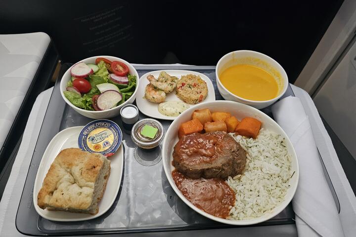 Braised beef with domoda sauce, steamed rice and roasted root vegetables.