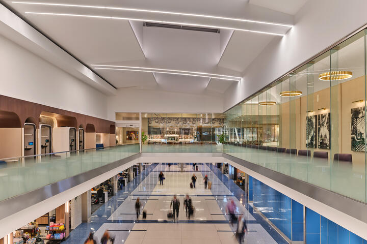 View from mezzanine level overlooking CLT airport's airfield and concourse below.